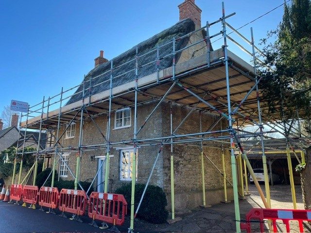 Renovation of a house with scaffolding and safety barriers in place.